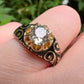 19TH CENTURY DIAMOND RING WITH BLACK ENAMEL SCROLL BAND