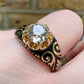 19TH CENTURY DIAMOND RING WITH BLACK ENAMEL SCROLL BAND