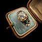 19TH CENTURY DIAMOND RING WITH BLACK ENAMEL SCROLL BAND