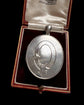 LARGE SCALE VICTORIAN SILVER ‘GARTER MOTIF’ LOCKET
