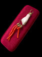 19TH CENTURY CORAL HAND WITH AMULETS