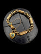 GEORGIAN 15CT GOLD BRACELET WITH A GEM SET HAND, SNAKE & HEART CLASP