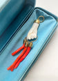 19TH CENTURY CORAL HAND WITH AMULETS