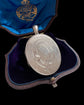 LARGE SCALE VICTORIAN SILVER ‘GARTER MOTIF’ LOCKET