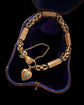 GEORGIAN 15CT GOLD BRACELET WITH A GEM SET HAND, SNAKE & HEART CLASP