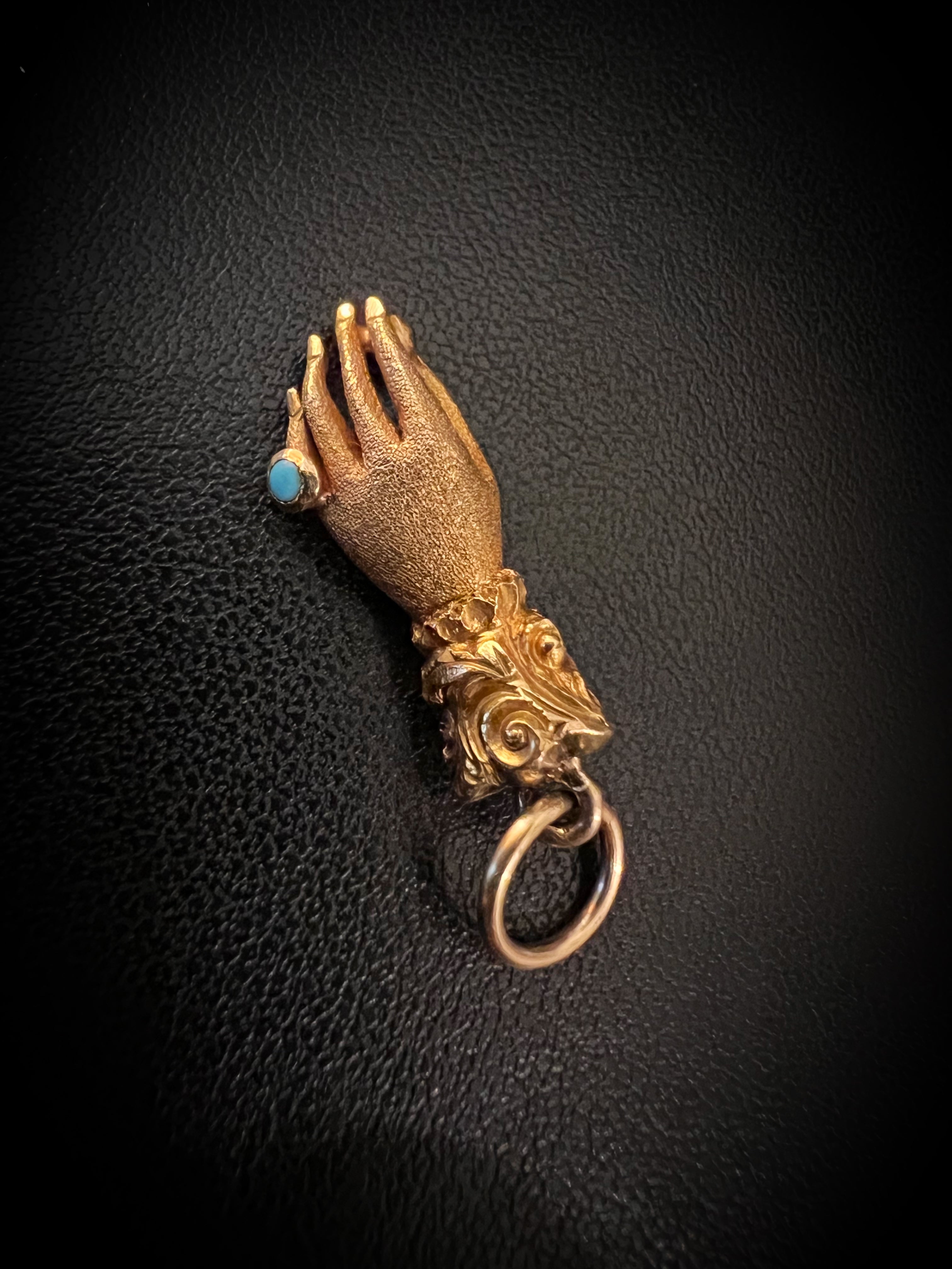 Gold fist on sale pendant