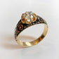 19TH CENTURY DIAMOND RING WITH BLACK ENAMEL SCROLL BAND